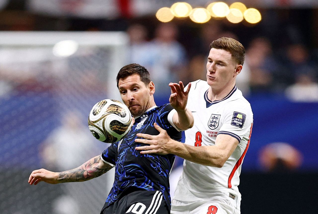 Messi is defended by England's Elliot Anderson in the first half.