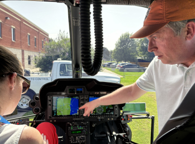 Aviation Supervisor Jeff Fletcher shows Wayne County, Mich. Commissioner Melissa Daub how the New Orleans Mosquito, Termite and Rodent Control Board's helicopter sprays for both mosquito adults and larvae. Photo by Charlie Ban