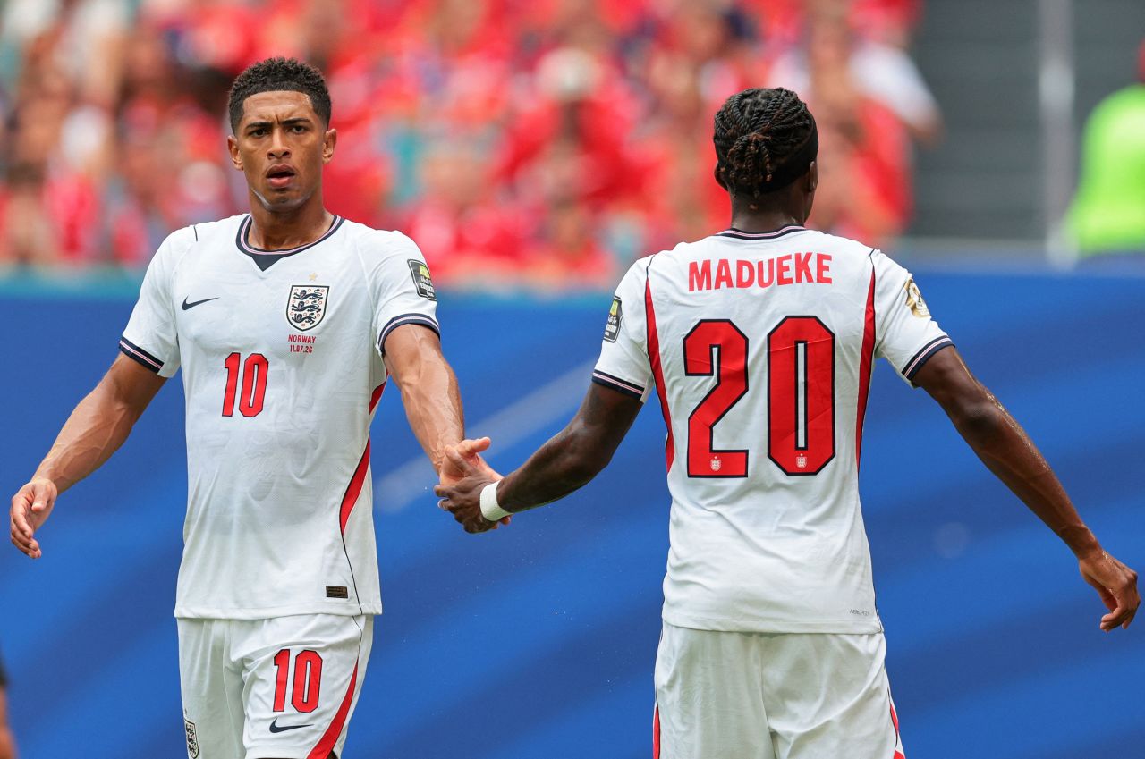 England's Jude Bellingham and Noni Madueke shake hands during the match.
