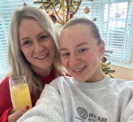 Jane Coates and her daughter, Lucy Harrison, in front of a Christmas tree