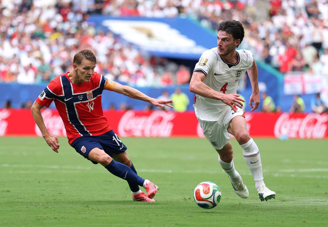 Norway's Martin Odegaard, left, competes for the ball with England's Declan Rice.