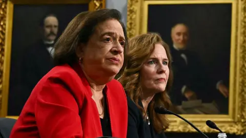 AFP via Getty Images Justices Elena Kagan (left) and Amy Coney Barrett (right) sit before the House Appropriations Committee in July