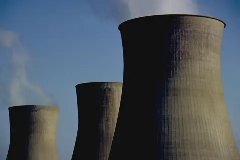 Getty Images The photo shows three huge chimneys of a nuclear power plant, location unspecified.