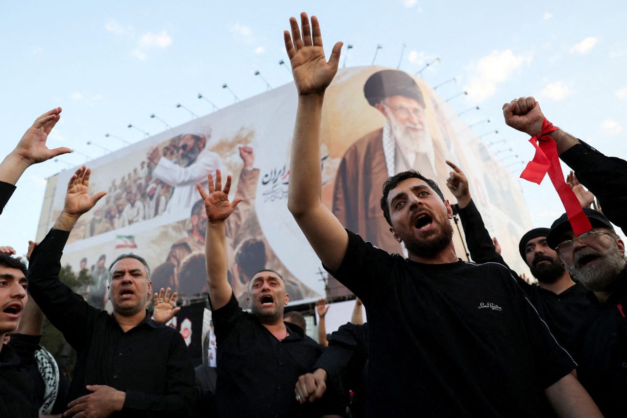 Mourners shout slogans on the day of the funeral procession.