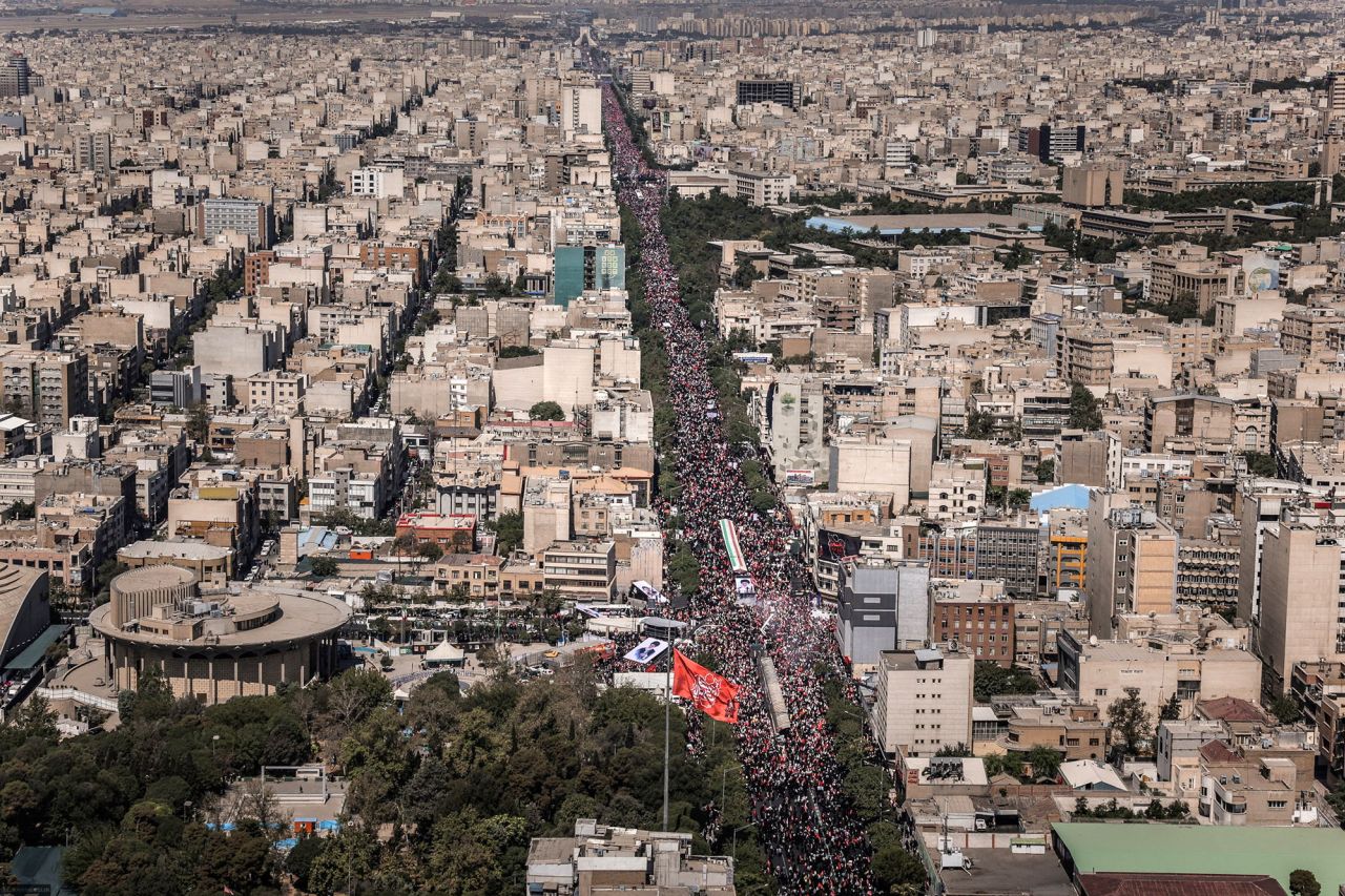 People attend a funeral procession for Iran's late Supreme Leader Ayatollah Ali Khamenei in Tehran on Monday.