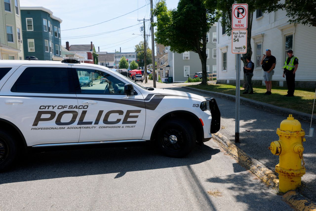 A police vehicle is parked near a scene of a shooting involving US Immigration and Customs Enforcement in Biddeford, Maine, on Monday.