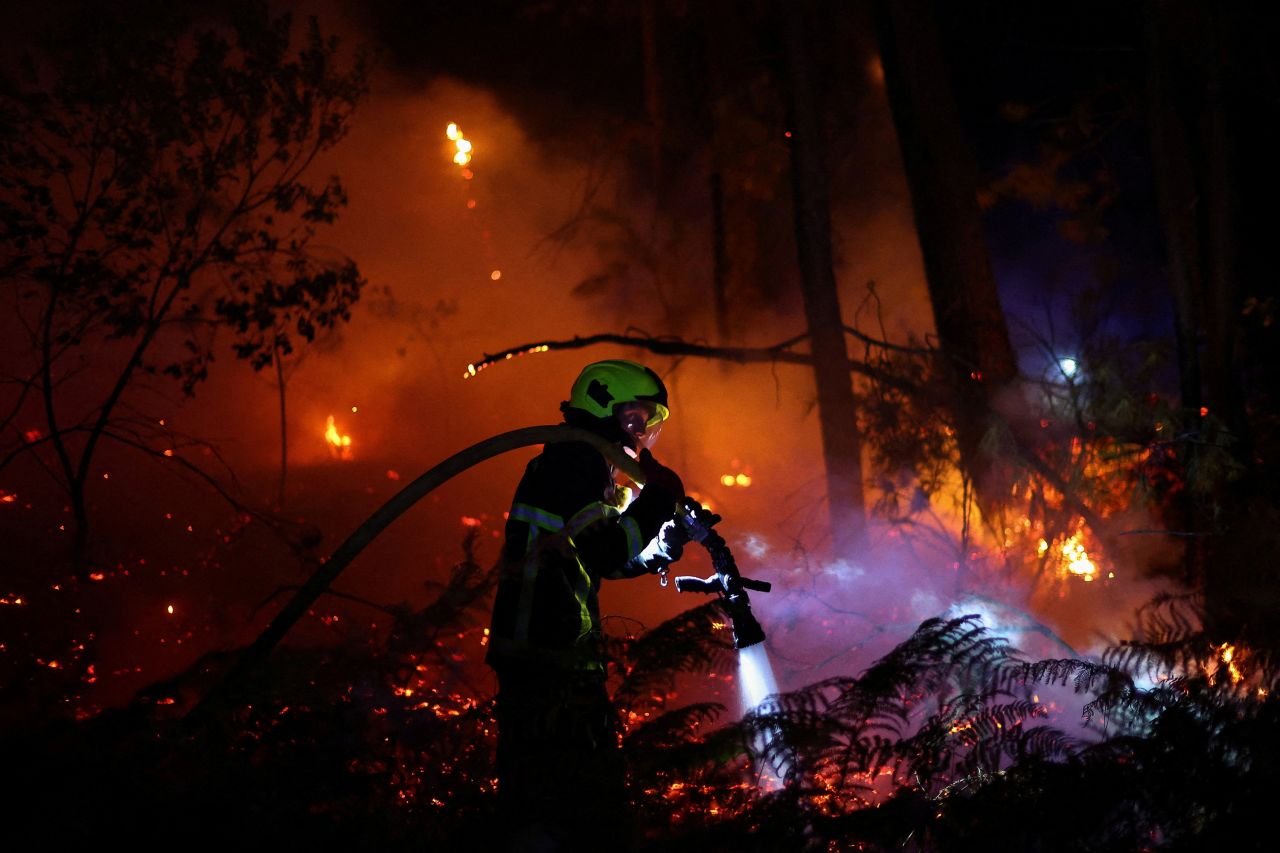 A firefighter works at the scene of a wildfire in Andernos-les-Bains, France on Sunday.