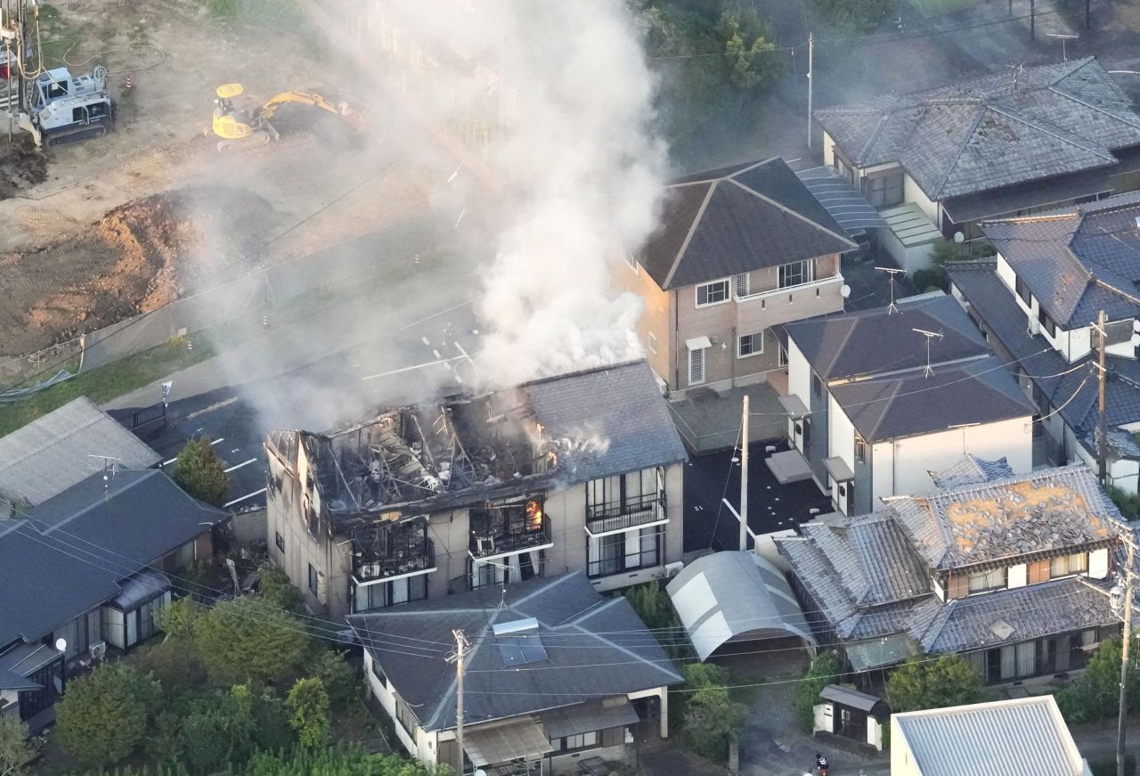 A residential building burns after an earthquake in Kumamoto.