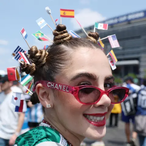 Reuters A fan wears the flags of the competing nations in her hair outside the New York New Jersey stadium.