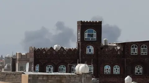 Reuters Smoke rises over Sanaa aiport, Yemen (13 July 2026)
