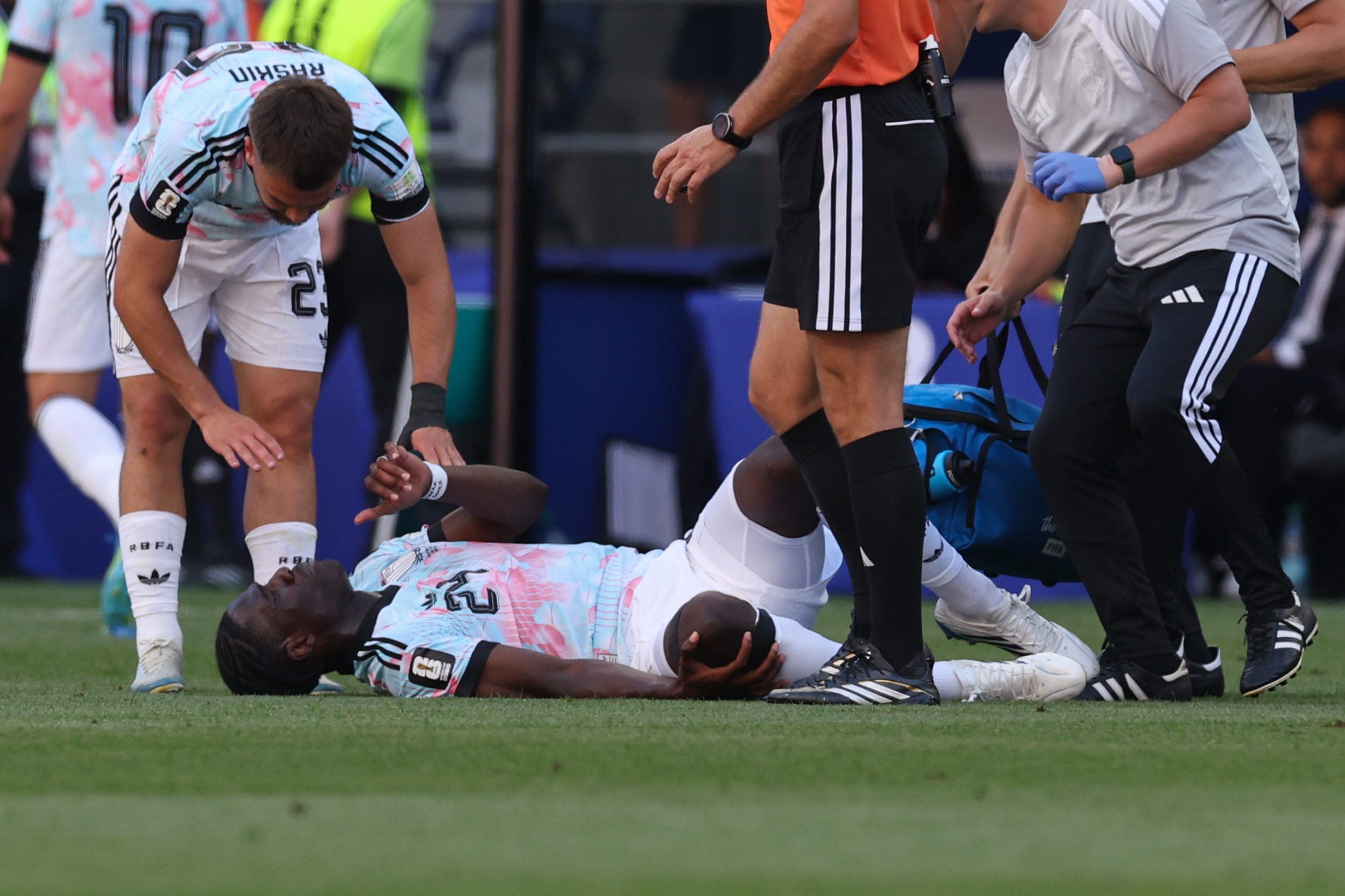 Belgium's Amadou Onana (24) lies on the field after an injury during the match between the United States and Belgium in Seattle.