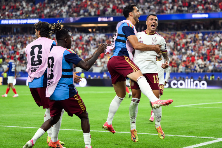 Pedro Porro celebrates with teammates on the soccer field