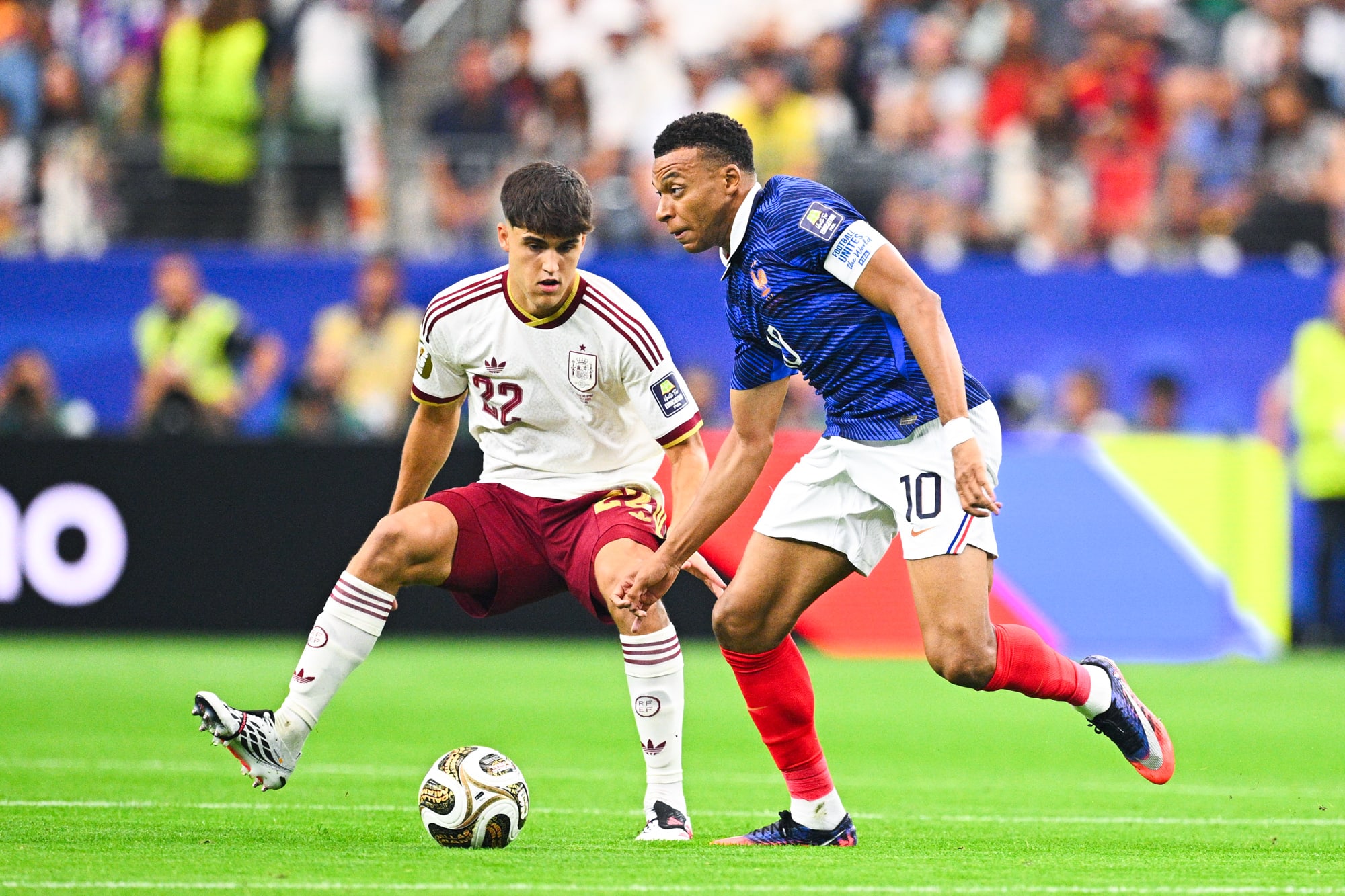 Kylian Mbappé, right, runs next to Pau Cubarsi on the soccer field