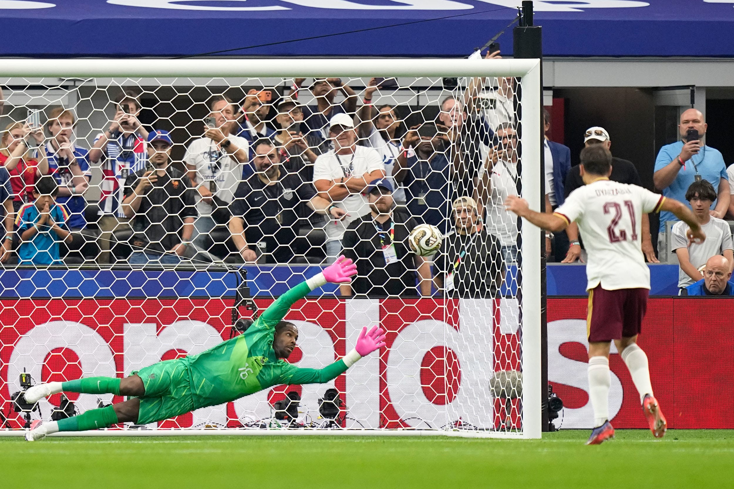 Spain's Mikel Oyarzabal scores the opening goal from the penalty spot past France's goalkeeper Mike Maignan.