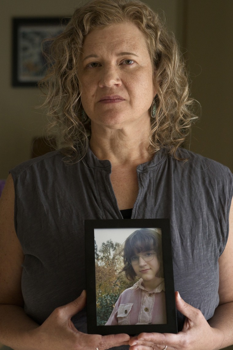 Elyse Thorpe holds a framed photo of May.