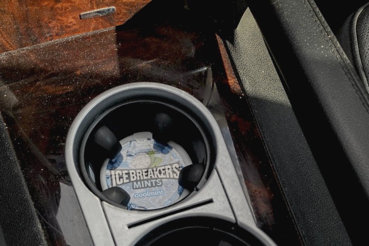 A mints container in a cup holder in Joseph Pollard's car.