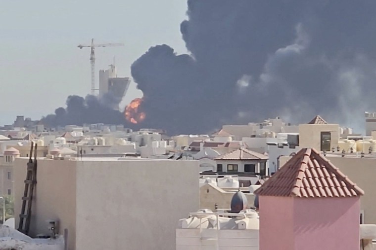 Smoke billows near the oil facility in Mangaf