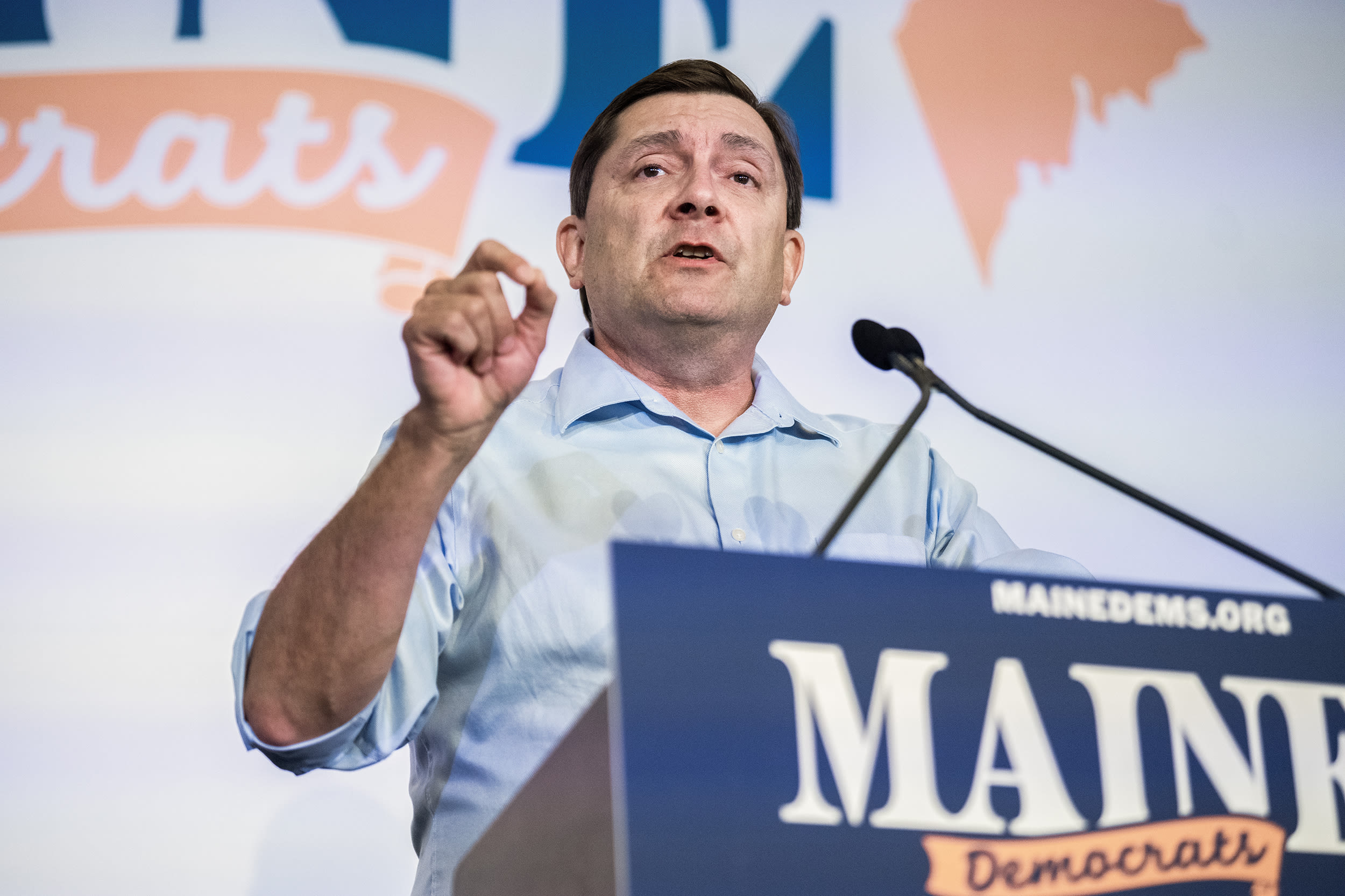 Troy Jackson speaking at a lectern.
