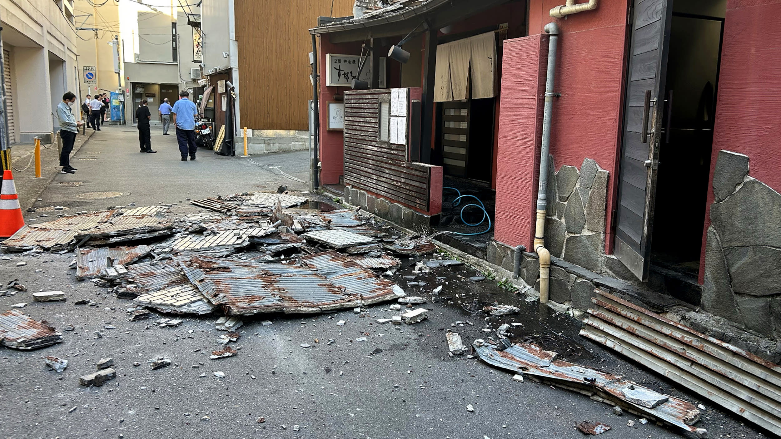 The exterior wall of a shop is seen collapsed in an earthquake, in Kumamoto City on July 28, 2026.
