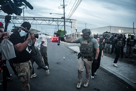 An Immigration and Customs Enforcement (ICE) agent fires tear gas toward demonstrators and members of the press at the Delaney Hall Detention Facility.
