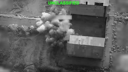 A building going up in smoke, seen from the air.