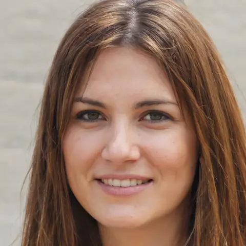 Nightingale A young woman with shoulder length brown hair smiling at the camera