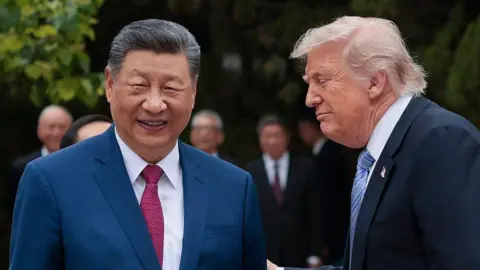 Getty Images Closeup of Xi and Trump wearing suits, and smiling