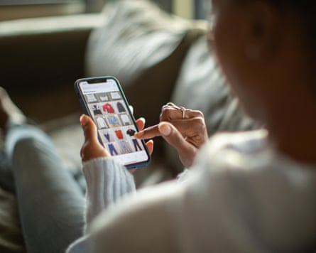 A person scrolls through clothing listings on Depop