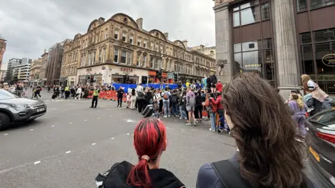 PA Media Crowds of people watch filming in the centre of Glasgow