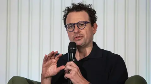 Bloomberg via Getty Images Anthropic chief executive Dario Amodei speaks through a microphone during a summit
