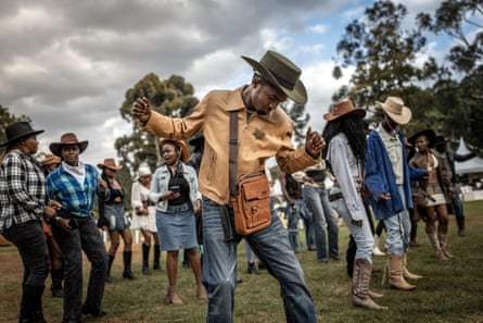 Revellers in cowboy attire dance to country music at Ngong Racecourse in Nairobi.