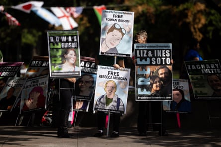 people hold up signs in protest