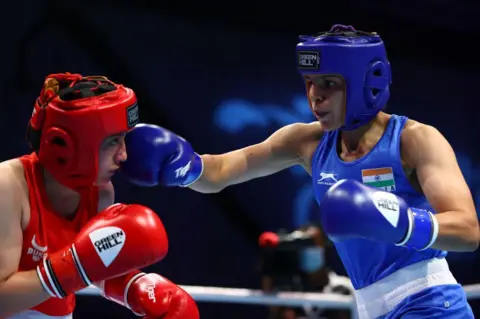 Getty Images Oyuntsetseg Yesugen of Uzbekistan (red) in action against Jaismine of India in the Women's Feather (54-57kg)preliminary bout on Day Two of the Asian Boxing Championships on May 25, 2021 in Dubai, United Arab Emirates. (Photo by Francois Nel/Getty Images)
