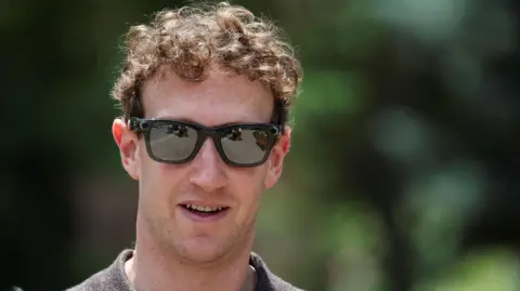 Reuters Meta CEO Mark Zuckerberg walking outside wearing a polo-style shirt and a pair of his company's camera-enabled sunglasses.