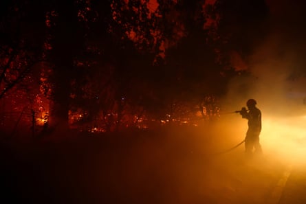 A firefighter battles flames in Cap Ferret