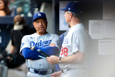two men in baseball uniforms stand near each other