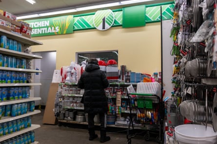 A person shops in a cluttered general store