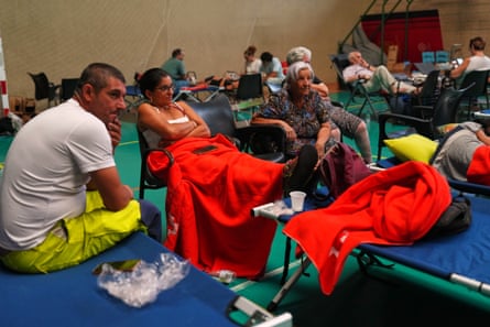 People spend the night at a sports centre after being evacuated from their homes in Cebreros, Ávila province