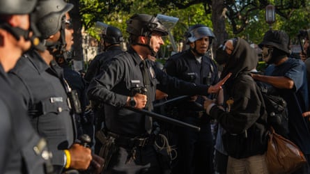 police pushing away a student