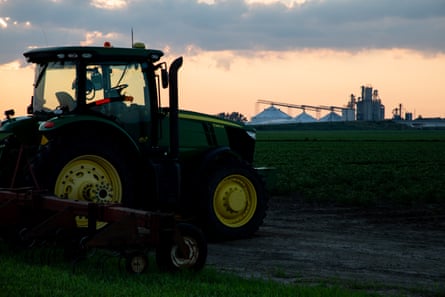 A tractor sits near a field.