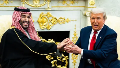 Getty Images A file image of Saudi Crown Prince Mohammed bin Salman holding an extended handshake in the White House Oval Office with US President Donald Trump