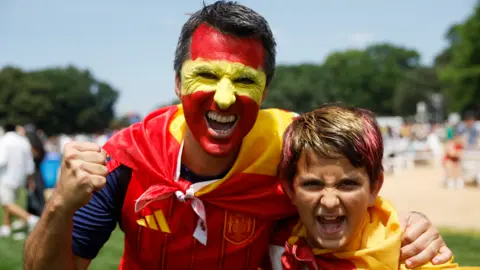Reuters Spain fans, one with his face painted in the national colours, pose as supporters gather in Central Park before the FIFA World Cup final