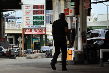 a person walks at a gas station