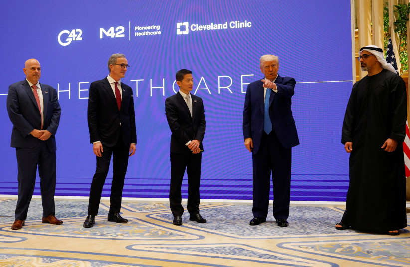 US President Donald Trump speaks next to Crown Prince of Abu Dhabi Sheikh Khaled bin Mohamed bin Zayed Al Nahyan, CEO of Cleveland Clinic Tom Mihaljevic and CEO of G42 Peng Xiao as he attends a business forum at Qasr Al Watan during the final stop of his Gulf visit, in Abu Dhabi, UAE.