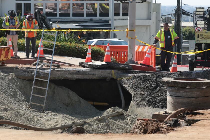 WEST HOLLYWOOD, CA JULY 17, 2026 - Repair work is underway after a water main break flooded streets in West Hollywood, and shut down a portion of Sunset Boulevard on Friday morning, July 17, 2026. (Myung J. Chun / Los Angeles Times)