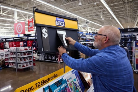 An associate updates the price on a sale item at a Walmart store on Black Friday in Columbus, Ohio, US, on Friday, Nov. 28, 2025.
