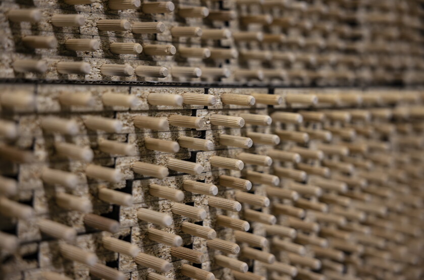 Rows of particle board with wooden dowl pins on the end can be seen at Inno Line, a 538,000-square-foot production facility in Klaipėda, Lithuania, on April 22.