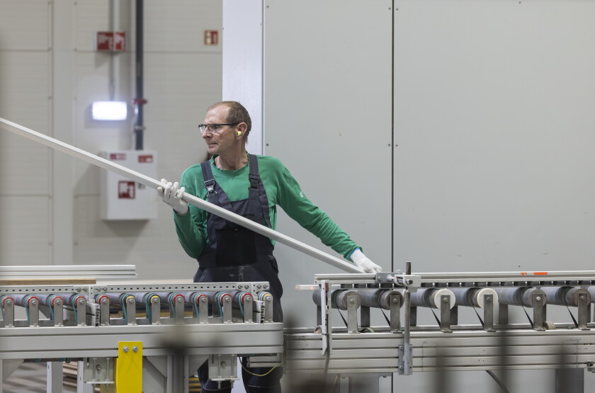 An employee works on the automated machines that build furniture components at Inno Line, a 538,000-square-foot production facility in Klaipėda, Lithuania, on April 22.
