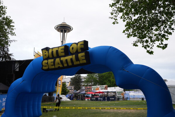 The entrance to "Bite of Seattle" is seen as police respond to a shooting at Seattle Center during the food festival Sunday, July 26, 2026, in Seattle, Wash. (AP Photo/Lindsey Wasson)