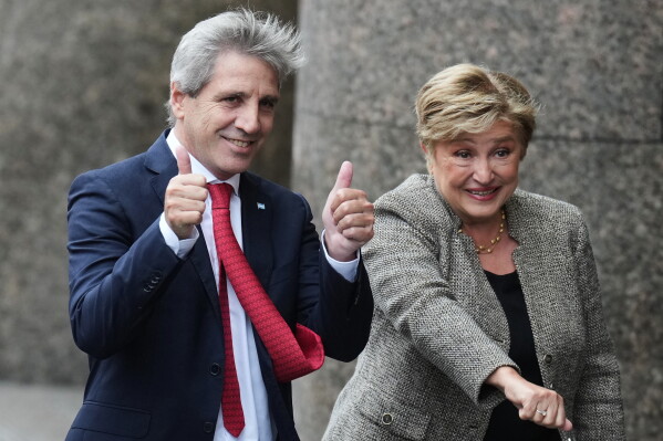 President of the International Monetary Fund Kristalina Georgieva, right, and Argentina Economy Minister Luis Caputo pose for a photo as they arrive at the Economy Ministry for a meeting in Buenos Aires, Argentina, Monday, July 27, 2026. (AP Photo/Gustavo Garello)